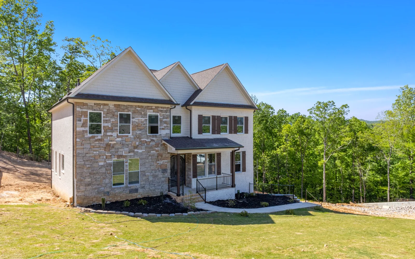 Completed two-story residential project with stone and brick exterior
